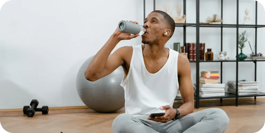 man drinking water during work out